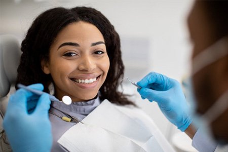 a patient smiling while undergoing a dental checkup