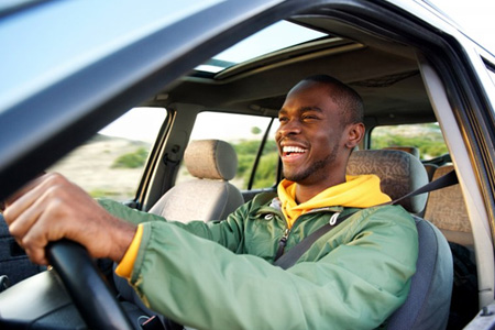 Man smiles while driving
