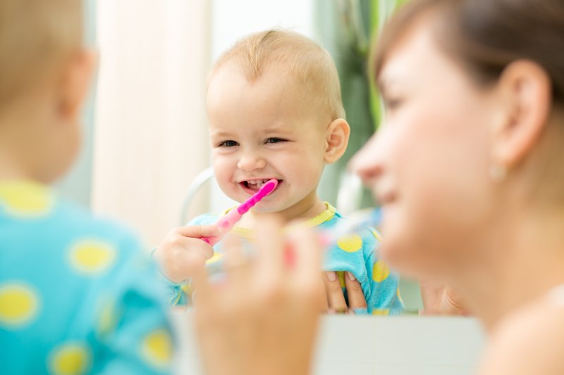 Mom and kid brushing their teeth