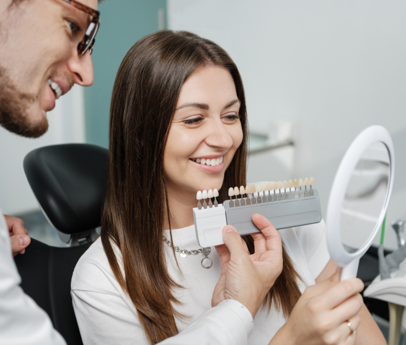 Dentist showing patient veneer options